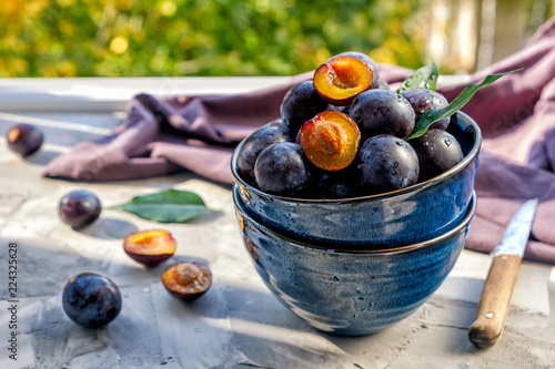 blue dish with mature fresh plums
