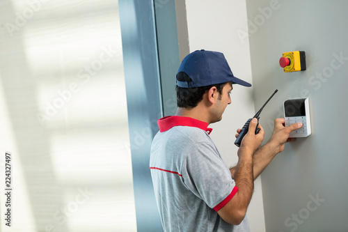 Techician set up security alarm
