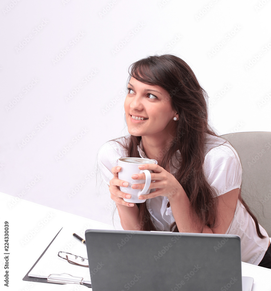 young woman with Cup of tea sitting in the workplace young woman with Cup of tea sitting in the workplace