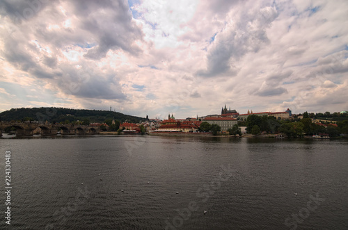 Panoramic view of historical center of Prague, Charles Bridge and Vltava river, Saint Vitus Cathedral at cloudy summer day. Buildings, cathedrals and landmarks of old town, Prague, Czech Republic