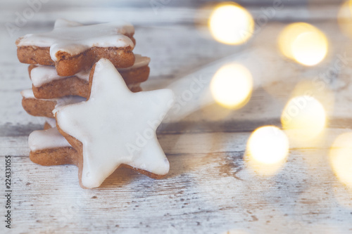 cinnamon stars at wooden background with light string