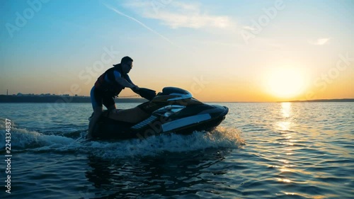 A man driving on a jet ski on water, close up. photo