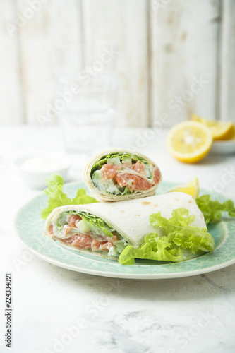 Salmon wraps with lettuce, cucumber and lemon