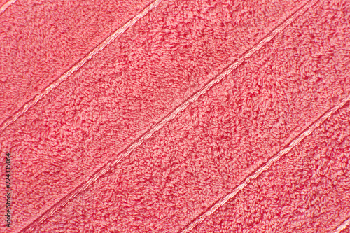 Texture of terry cloth. Background of fabric for sewing bath towels. Texture of soft tissue for bath towels in pink color.