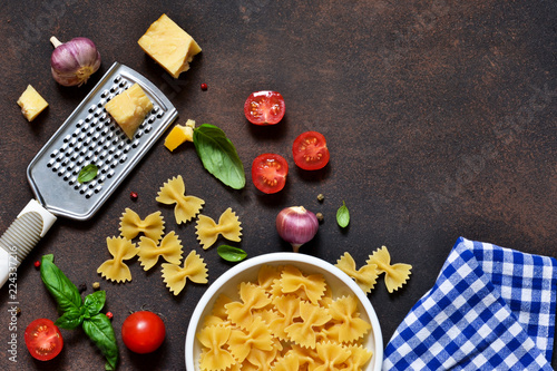 Food frame. Ingredients for pasta - cherry tomatoes, garlic, basil, Parmesan, top view.