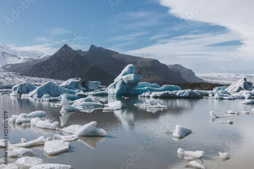 Melting glacier ice floating in lake in Fjallsarlon, Iceland photo