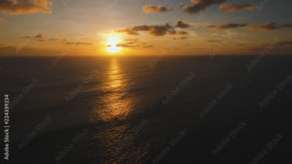 Aerial view orange sunset over the sea, the ocean. Flying over the blue ocean with blue water, sky. Bali,Indonesia.4K video. Travel concept. Aerial footage Aerial view orange sunset over the sea, the ocean. Flying over the blue ocean with blue water, sky. Bali,Indonesia.4K video. Travel concept. Aerial footage