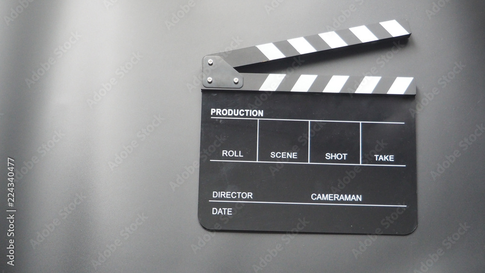 Clapper board or movie slate use in video production or movie and cinema industry. It's black color on black background.