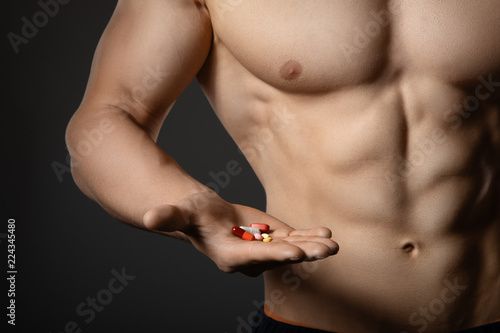  anabolic steroids or booster supplements in hand photo