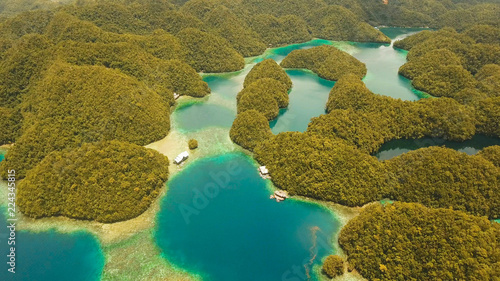 Aerial view: Bucas Grande Island, Sohoton Cove. Philippines. Tropical sea bay and lagoon, beach. Tropical landscape hill, clouds and mountains rocks with rainforest. Azure water of lagoon. Shore photo