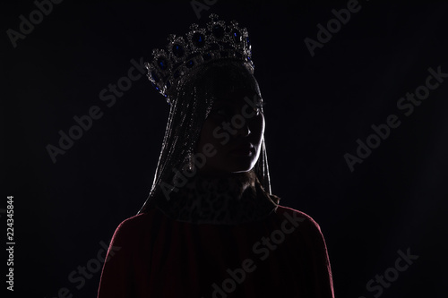 queen with crown, studio portrait on a black background photo