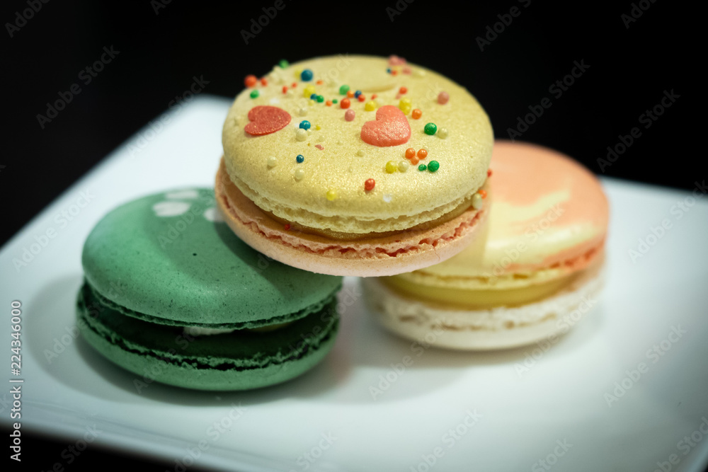 Homemade assorted macarons beautifully decorated with colorful hearts, green tea and yellow and gold color