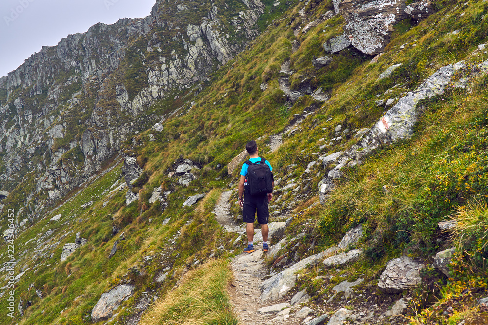 Hiker with backpack in the mountains