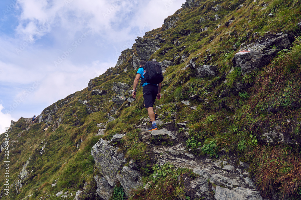 Hiker with backpack in the mountains Hiker with backpack in the mountains