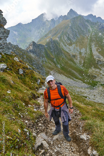 Hiker with backpack in the mountains © Xalanx