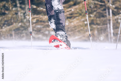 Man in snowshoes in the mountains. photo