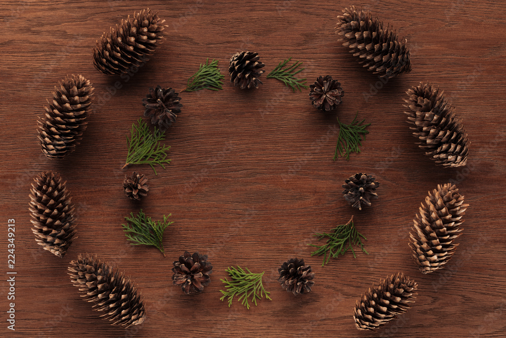 top view of beautiful evergreen coniferous twigs and pine cones on wooden background top view of beautiful evergreen coniferous twigs and pine cones on wooden background