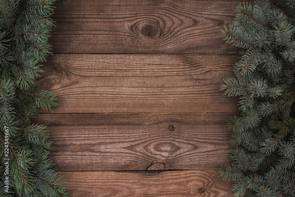 top view of beautiful evergreen coniferous branches on wooden background