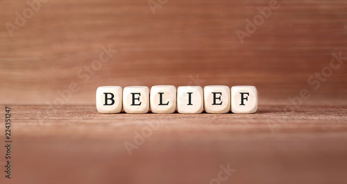 Word BELIEF made with wood building blocks