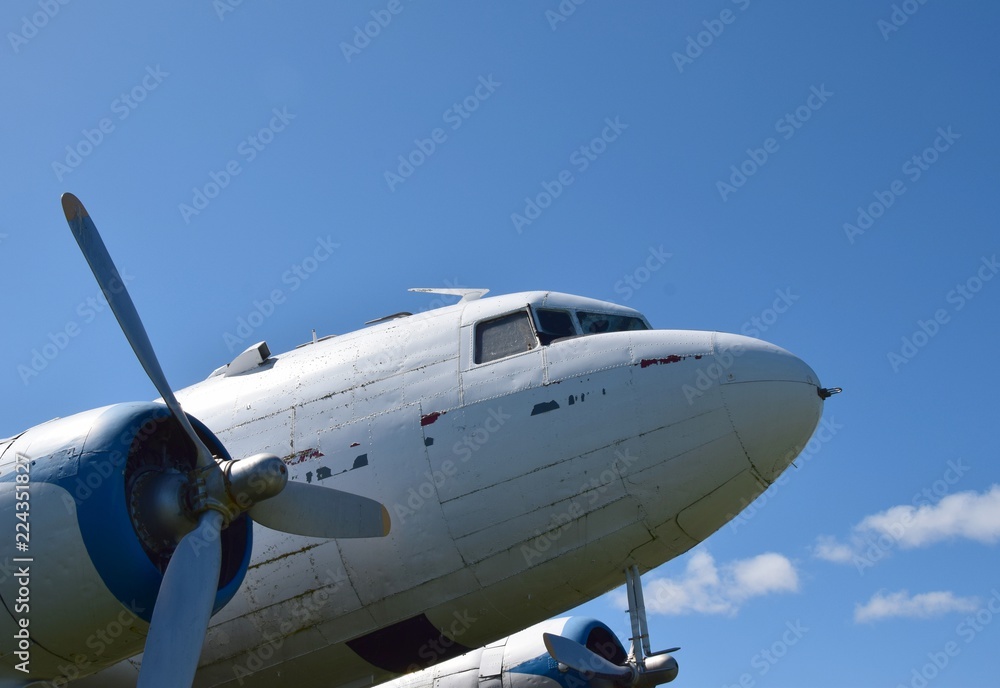 front end of an historic aircraft the DC-3, blue sky in the background front end of an historic aircraft the DC-3, blue sky in the background