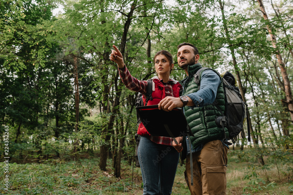 couple of travelers with map got lost in woods couple of travelers with map got lost in woods