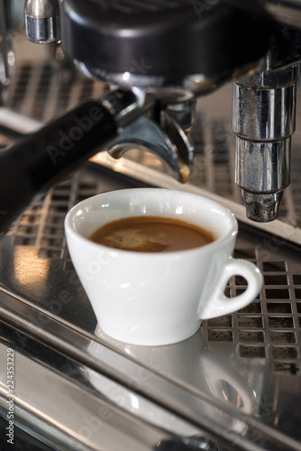 Professional coffee machine is preparing coffee speciality. Closeup.