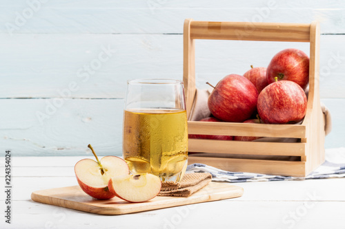 One glass of apple juice and fresh apple on white background. photo