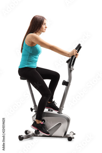 Young female riding a stationary bike