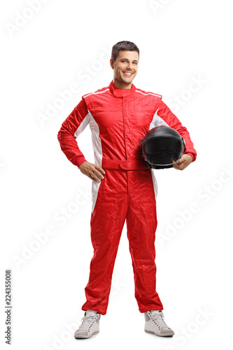 Racer standing and holding a helmet