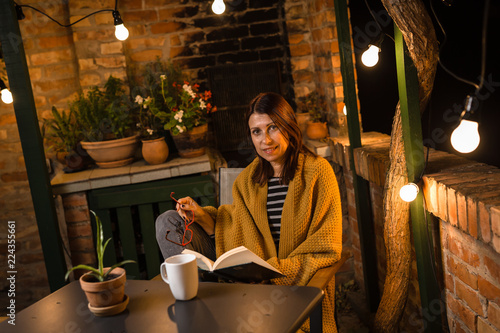 She likes to read book late night in her backyard