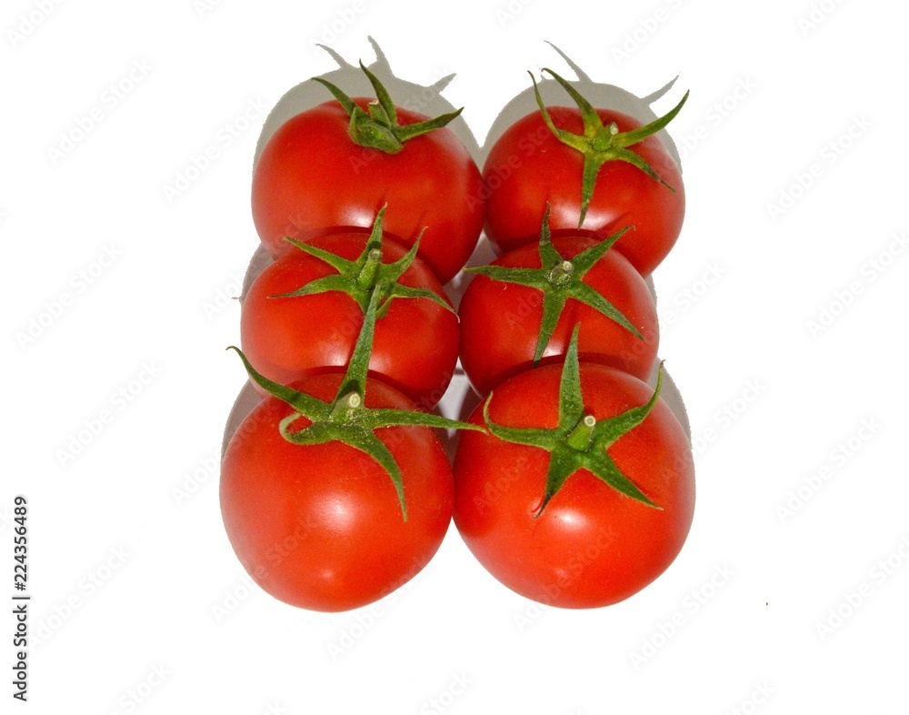 Ripe juicy red tomatoes lie on a white table, natural vitamins