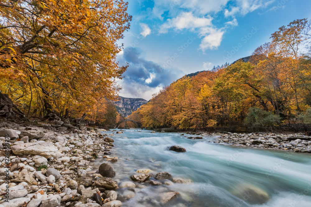 Old stone bridge in Klidonia Zagoria, Epirus, Western Greece. This arch bridge with elongated arch built in 1853.(Soft Focus) Long exposure using ND filter Old stone bridge in Klidonia Zagoria, Epirus, Western Greece. This arch bridge with elongated arch built in 1853.(Soft Focus) Long exposure using ND filter