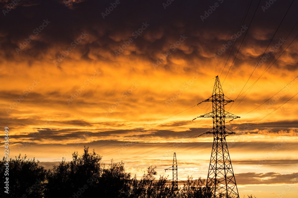 Fototapeta premium power lines against the backdrop of a bright sunset