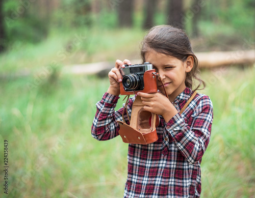 Young photographer. Small girl with camera. © volff