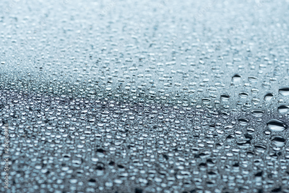 close up view of water drops on grey surface as background close up view of water drops on grey surface as background