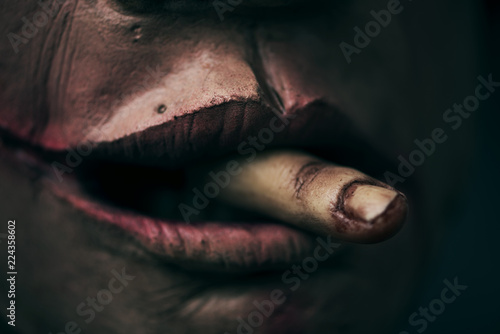 scary man with an amputated finger in his mouth