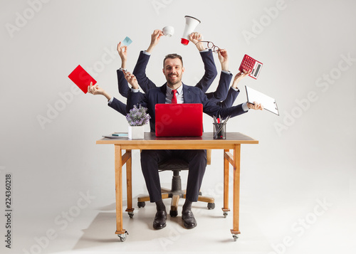 Fotografiet businessman with many hands in elegant suit working and holding office tools