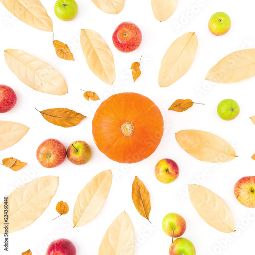 Fototapeta Naklejka Na Ścianę i Meble -  Autumn pattern with dried fall leaves, apples and pumpkin on white background. Flat lay, top view