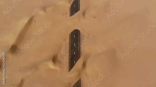 Aerial view of abandoned post apocalyptic roads covered in sand dunes