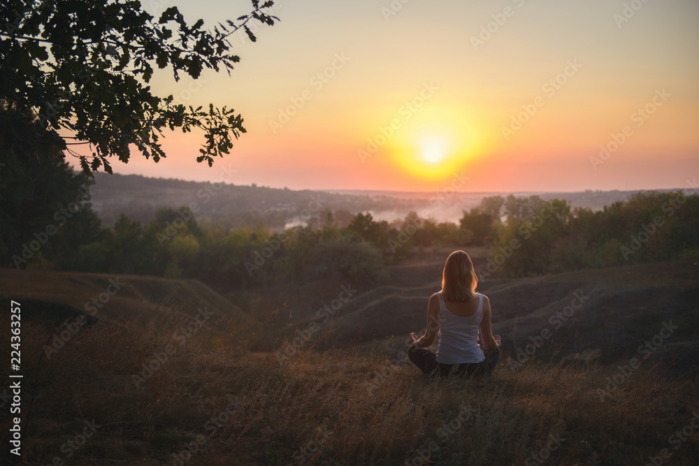 A girl meditating in the evening