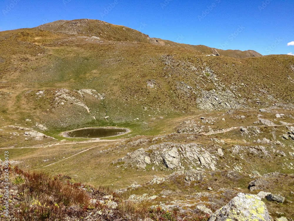 Panoramic view of a path that crosses the high pastures at the Sempione pass in Switzerland.