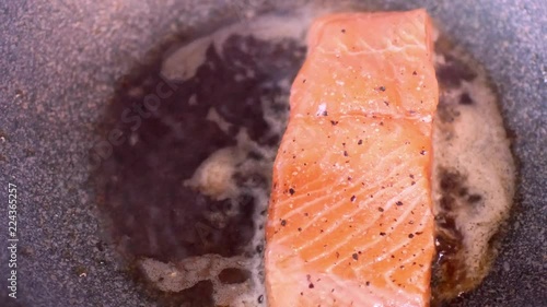 Fresh norwagian orange salmon fish filet was fried in the pan for salmon steak photo