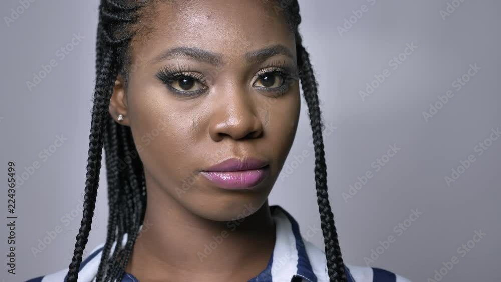 close-up portrait of african woman in dreads in grey studio close-up portrait of african woman in dreads in grey studio
