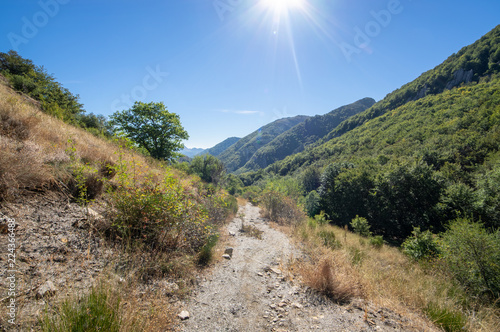 View of a valley in Leon mountain (Spain) during a trekking activity with the sun creating a flare effect