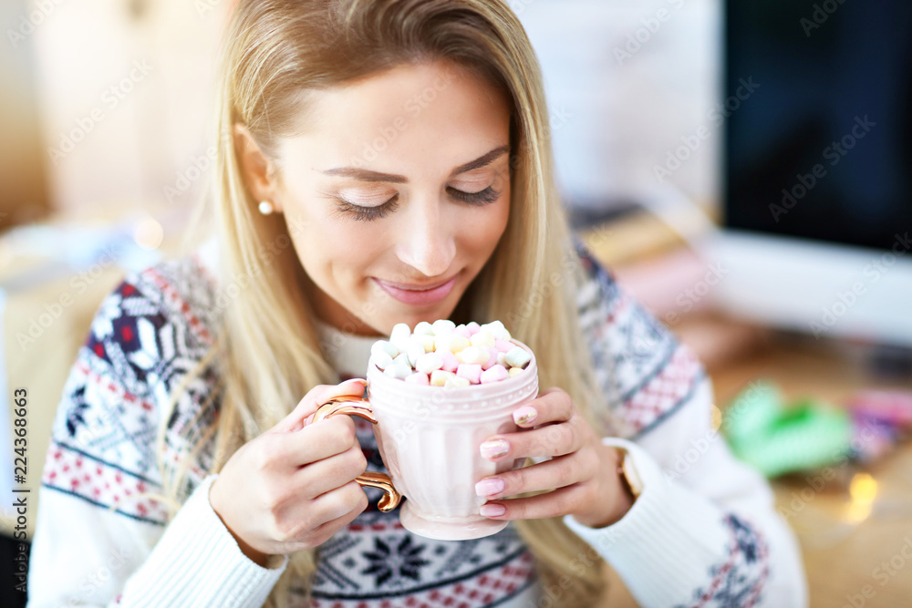 Adult woman relaxing at home during Christmas time Adult woman relaxing at home during Christmas time