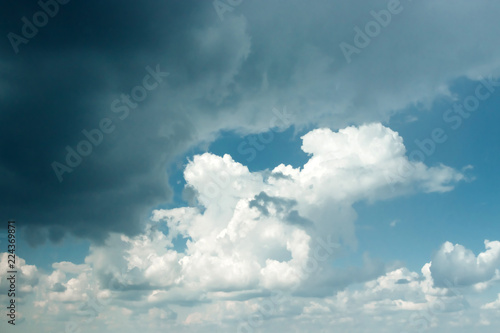 Fantastic, fluffy, white clouds against a blue sky. Rain clouds. The situation in the sky before the storm. copy space