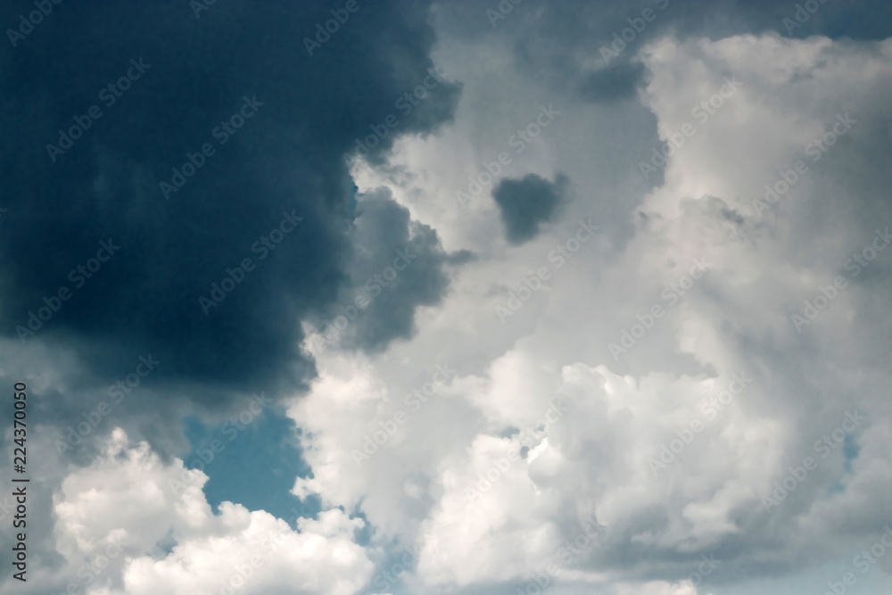 Obraz premium Fantastic, fluffy, white clouds against a blue sky. Rain clouds. The situation in the sky before the storm. copy space
