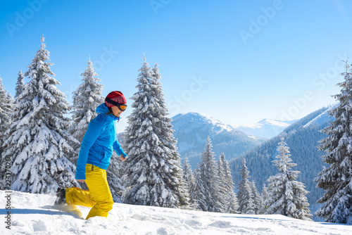 Joyful adventurer, woman is running in the winter mountains