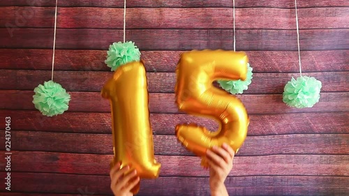 Happy fifteen birthday, golden air balloons with number 15, anniversary celebration with decorations