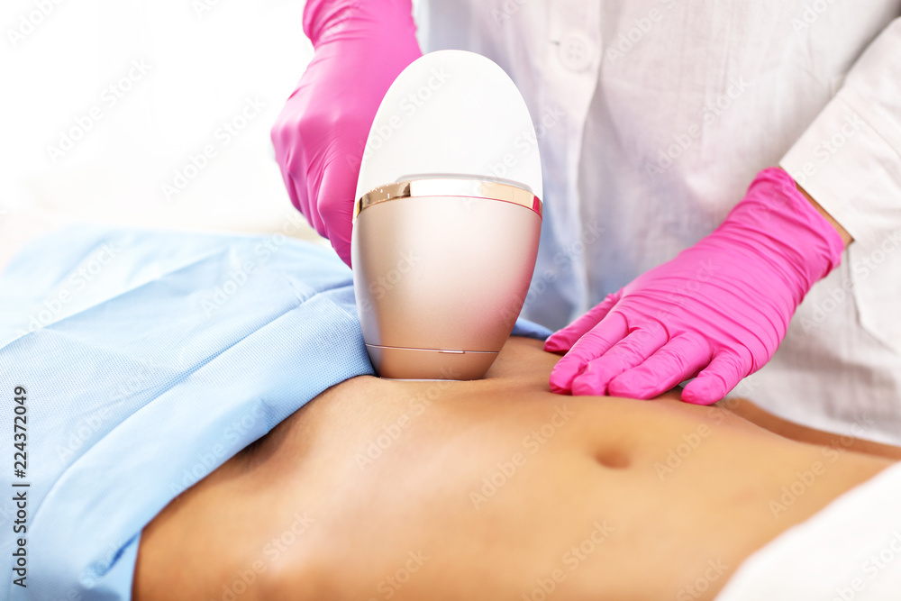 Adult woman having laser hair removal in professional beauty salon Adult woman having laser hair removal in professional beauty salon